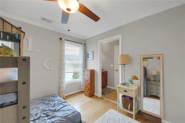 a bedroom with a bed dresser and a window