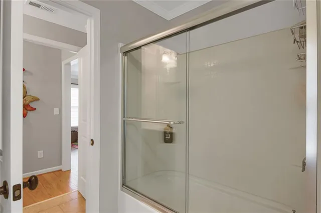a patio with table and chairs and potted plants