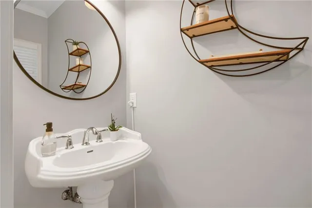 a bathroom with a sink and mirror