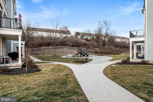 a view of a white building among the street with palm trees