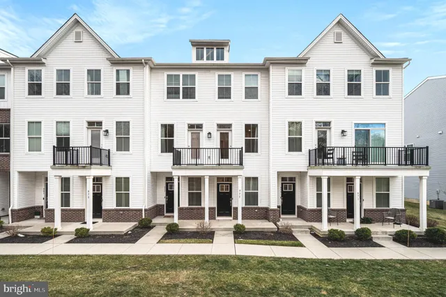 a front view of a building with windows and yard