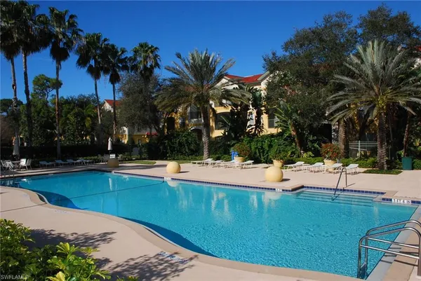 a view of a swimming pool with lounge chairs