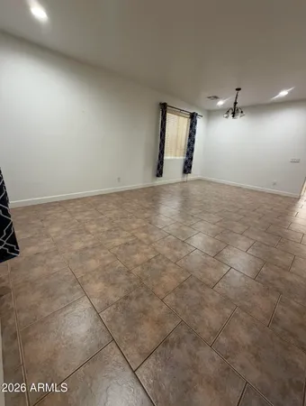 an empty room with a empty space and windows