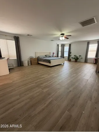 a view of a livingroom with furniture hardwood floor and a ceiling fan