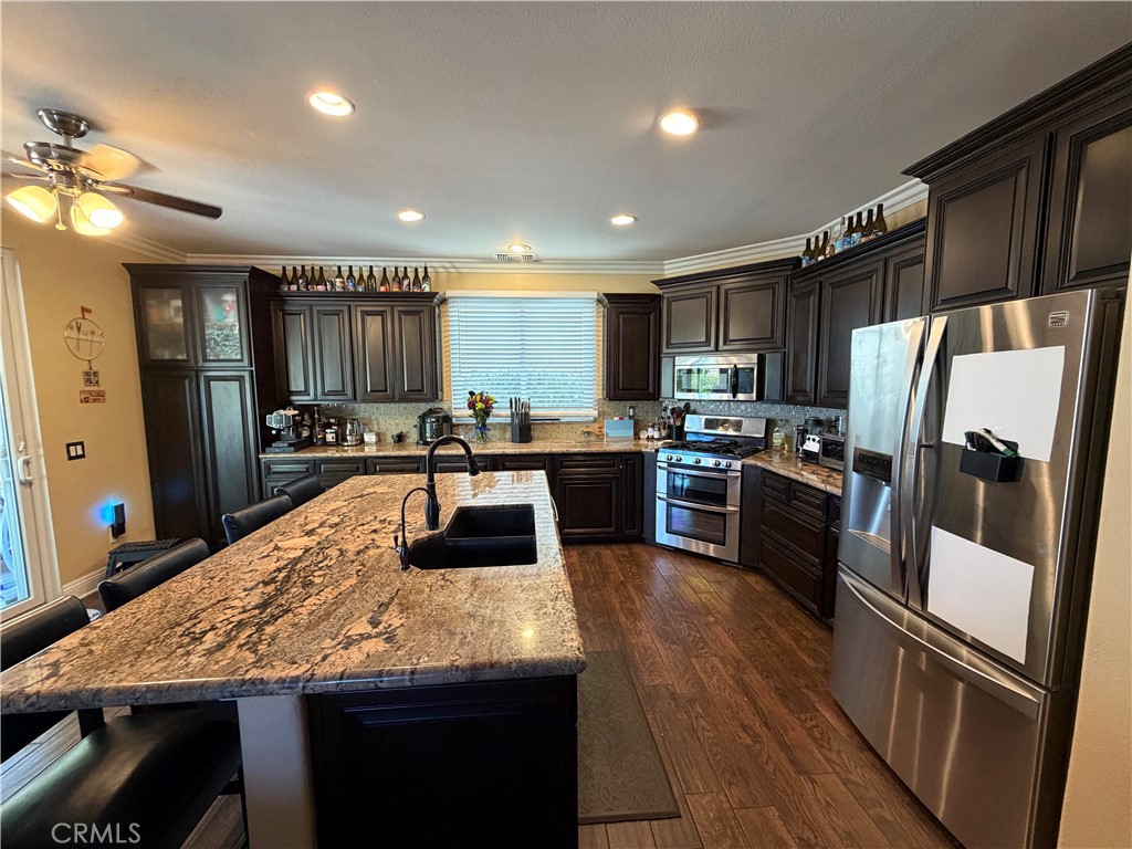 32044 Cypress Way Castaic, CA 91384 - Photo 16 of 59 a kitchen with stainless steel appliances granite countertop a refrigerator stove microwave and sink