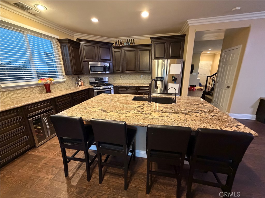 32044 Cypress Way Castaic, CA 91384 - Photo 19 of 59 a kitchen with kitchen island granite countertop wooden cabinets and stainless steel appliances