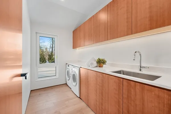 a kitchen with stainless steel appliances granite countertop a sink and dishwasher a stove top oven with wooden floor