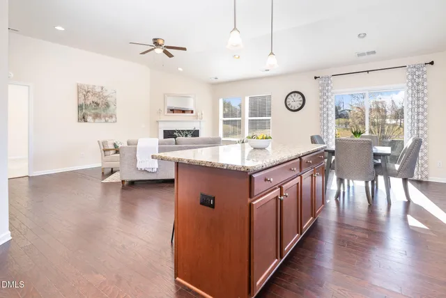 a bathroom with a sink toilet and potted plant