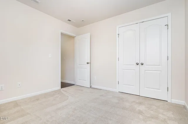 an empty room with a ceiling fan and a window