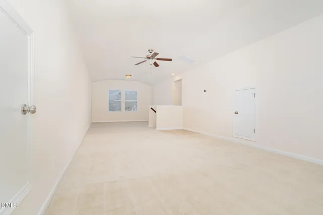a view of a house with a yard and covered with snow in the background