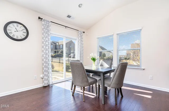 a kitchen with stainless steel appliances granite countertop a stove and chairs