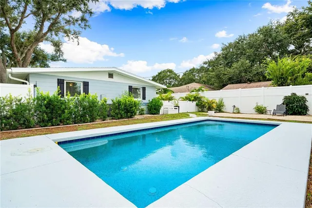 a view of a swimming pool with an outdoor seating
