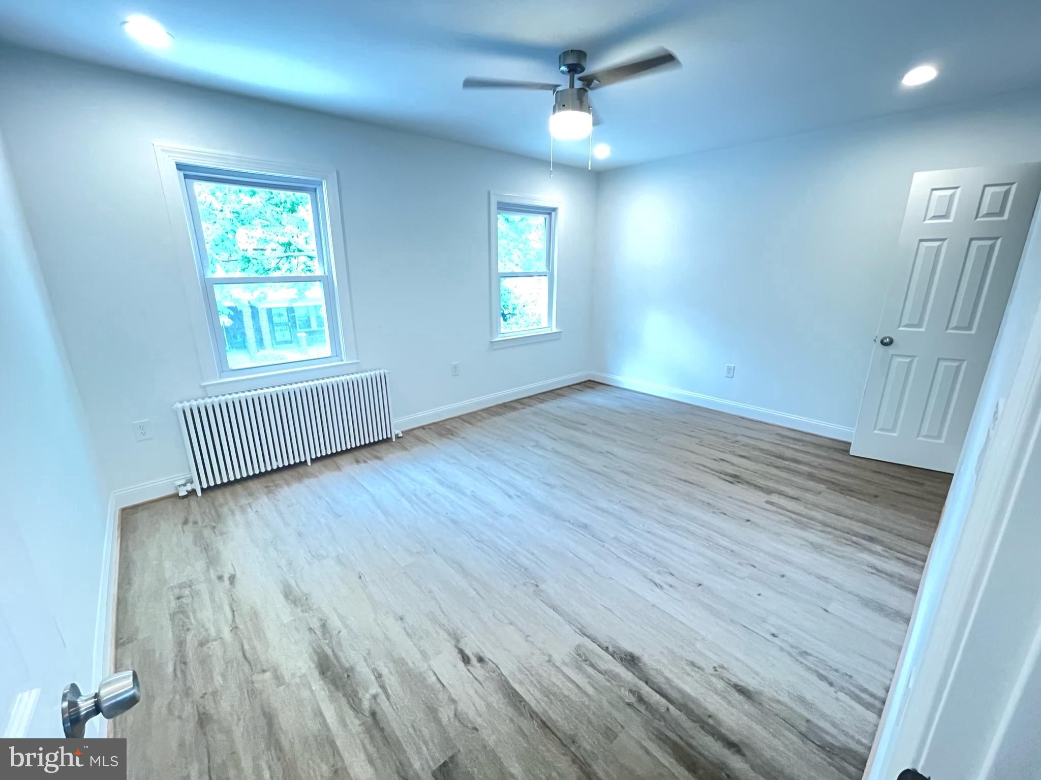 1718 Lang Place Northeast Washington, DC 20002 - Photo 13 of 32 wooden floor in an empty room with a window