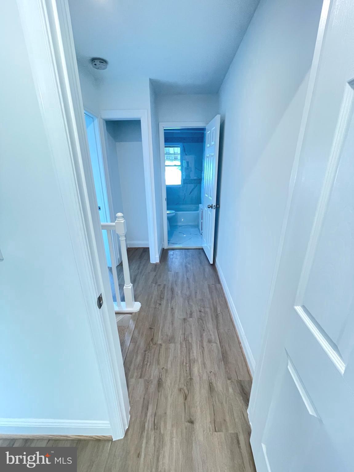 1718 Lang Place Northeast Washington, DC 20002 - Photo 16 of 32 a view of a hallway with wooden floor and staircase