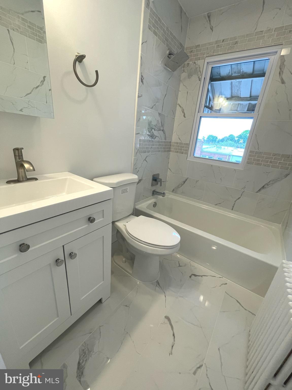 1718 Lang Place Northeast Washington, DC 20002 - Photo 19 of 32 a bathroom with a sink a toilet and shower
