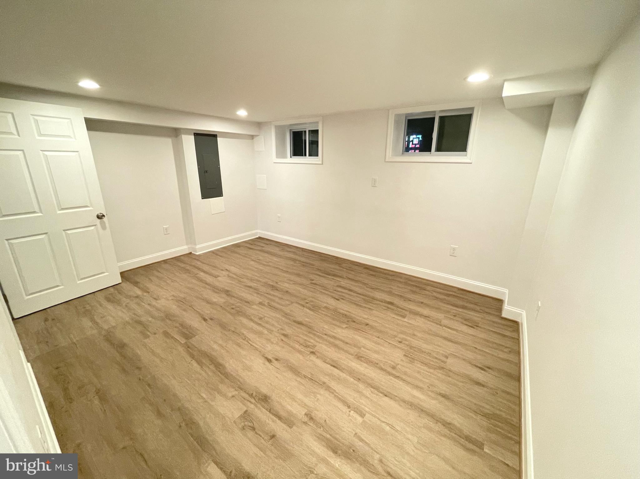 1718 Lang Place Northeast Washington, DC 20002 - Photo 20 of 32 a view of an empty room with wooden floor and a window