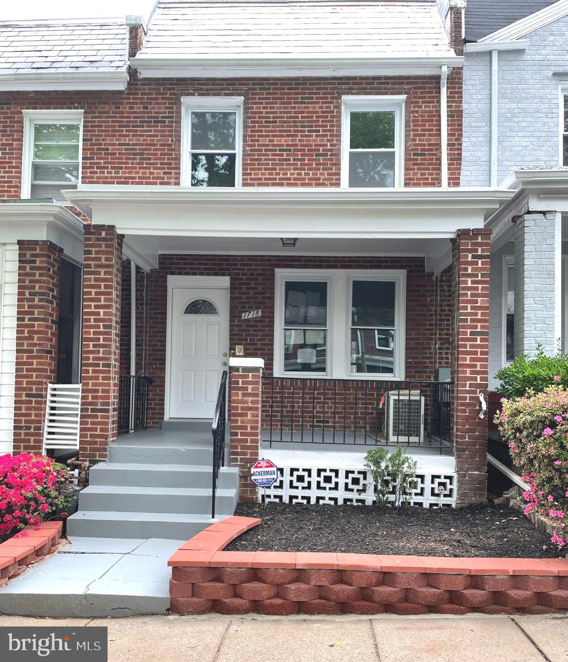 1718 Lang Place Northeast Washington, DC 20002 - Photo 2 of 32 a front view of a house with a garden