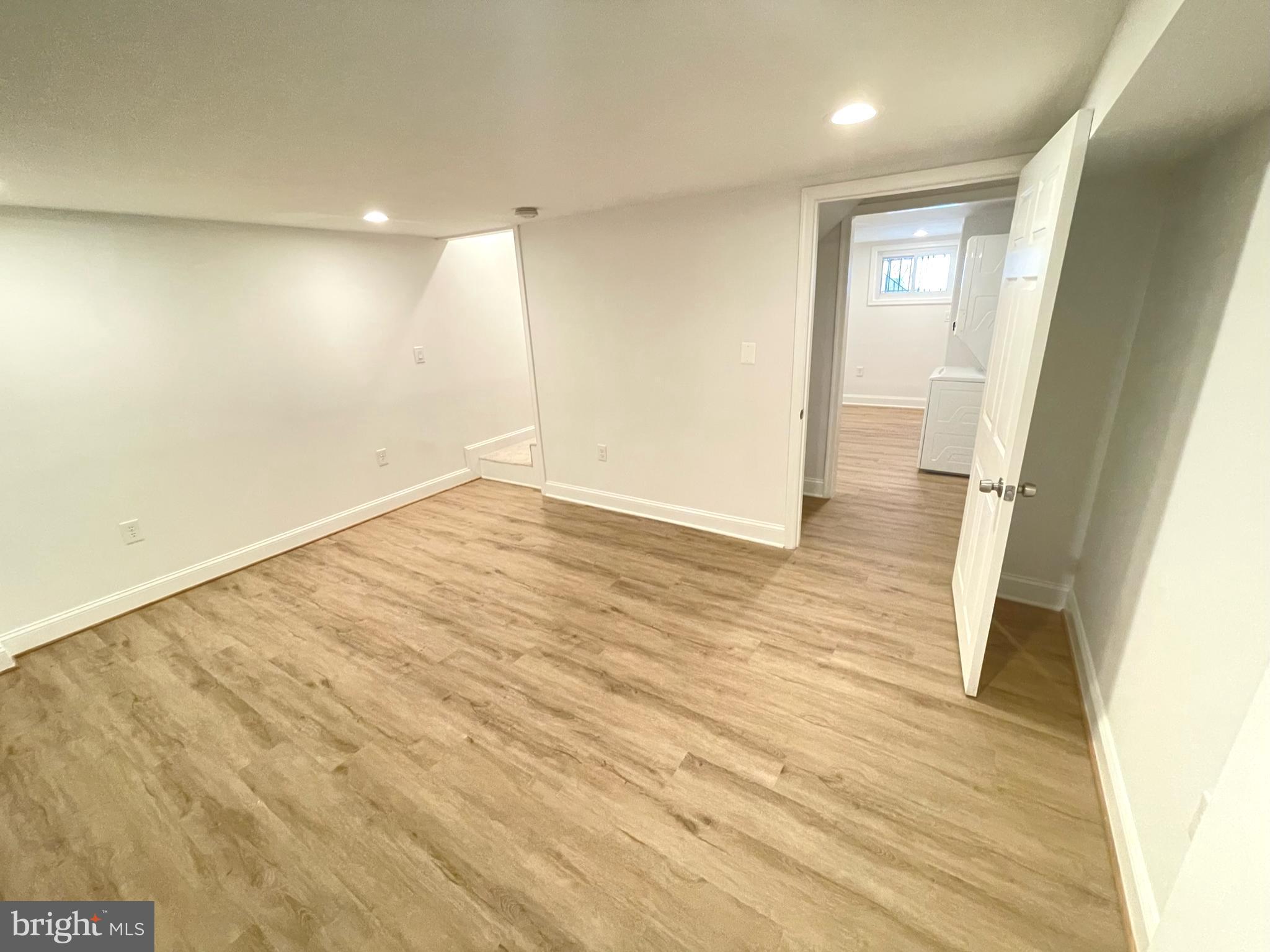 1718 Lang Place Northeast Washington, DC 20002 - Photo 21 of 32 an empty room with wooden floor and windows