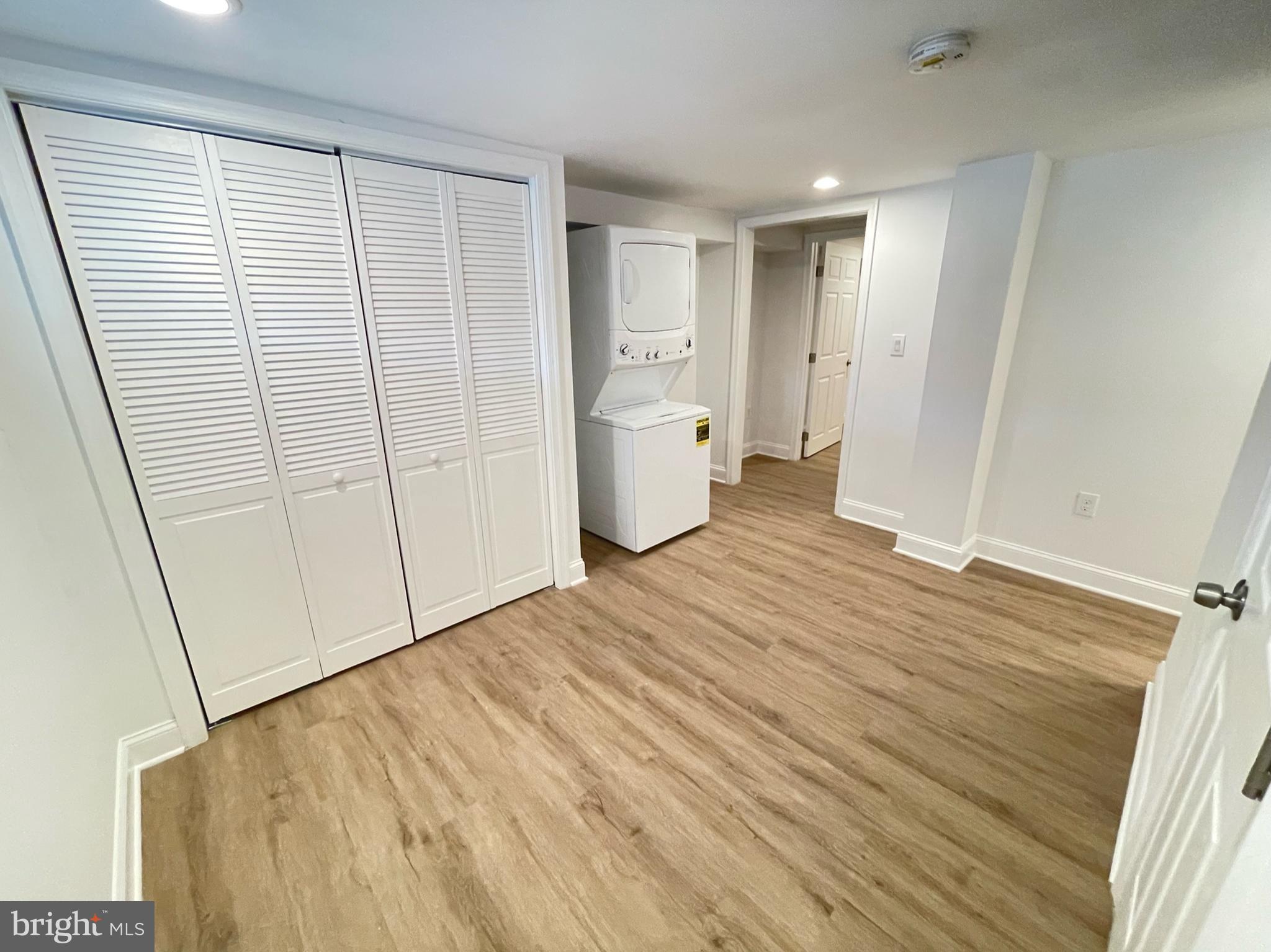 1718 Lang Place Northeast Washington, DC 20002 - Photo 24 of 32 a view of a room with wooden floor and white doors