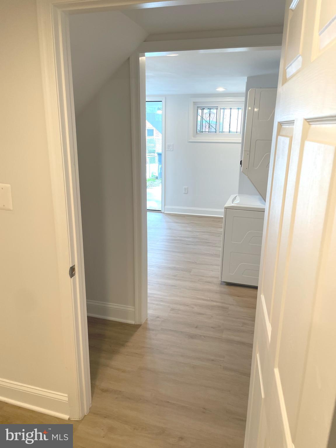 1718 Lang Place Northeast Washington, DC 20002 - Photo 27 of 32 a view of a hallway with wooden floor and a living room