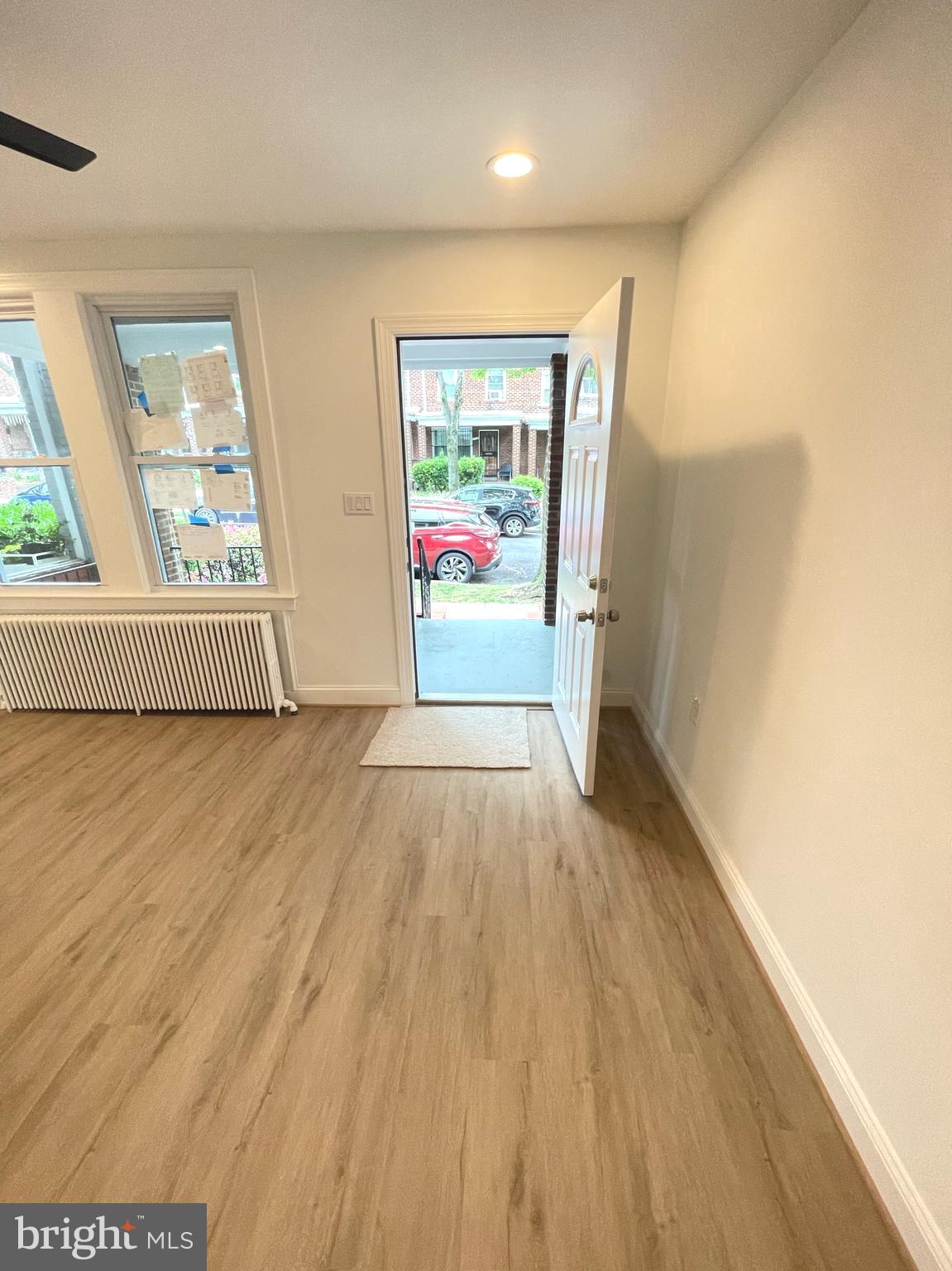 1718 Lang Place Northeast Washington, DC 20002 - Photo 4 of 32 wooden floor in an empty room with a window