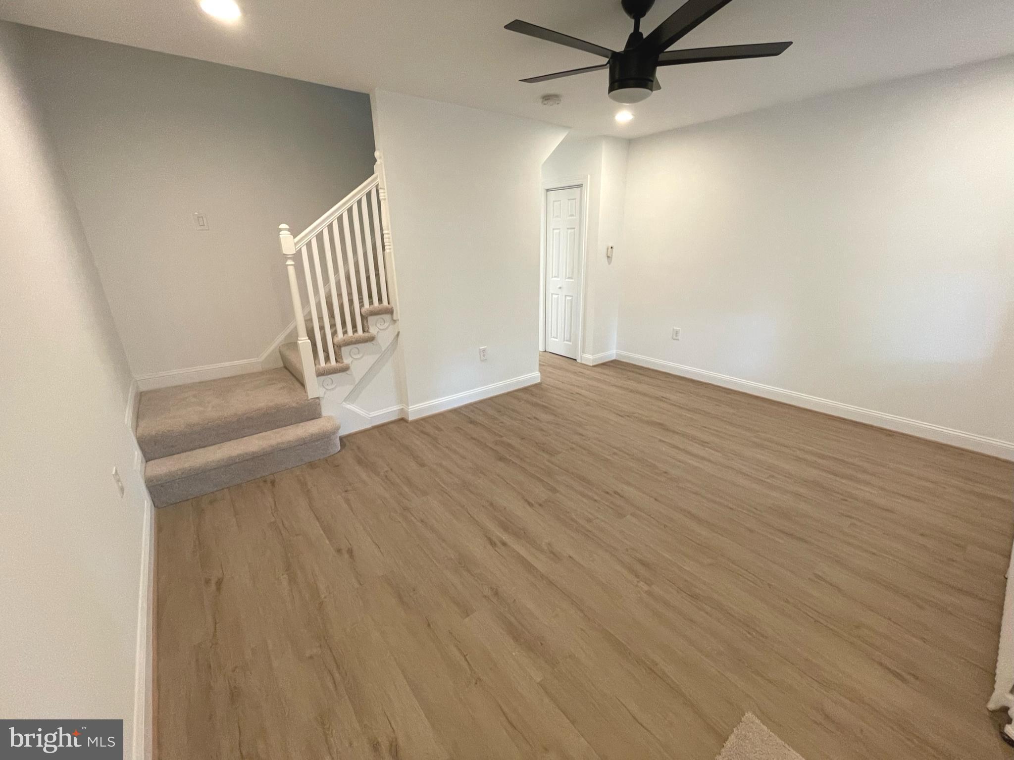 1718 Lang Place Northeast Washington, DC 20002 - Photo 5 of 32 wooden floor in a hall with a window