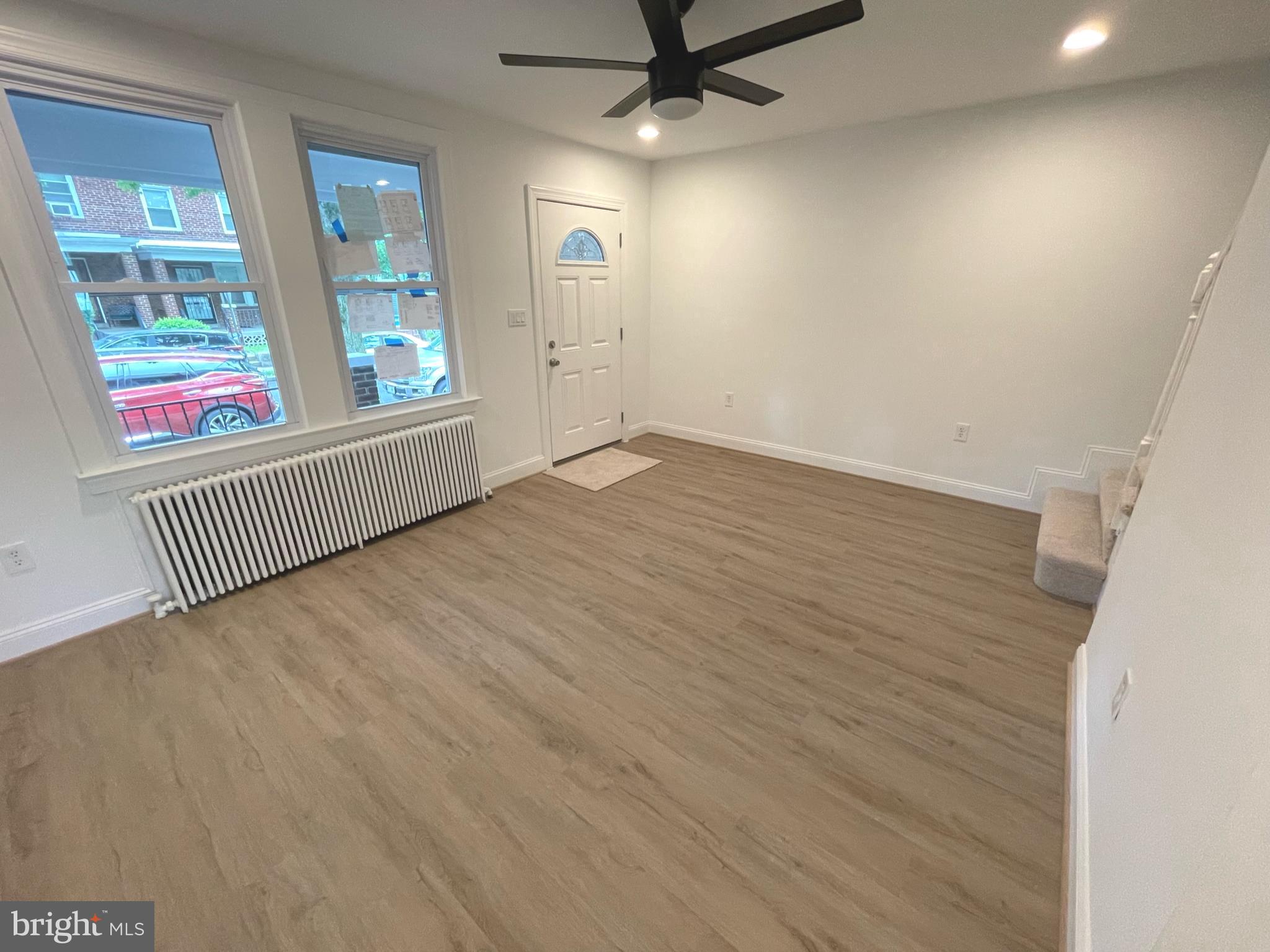1718 Lang Place Northeast Washington, DC 20002 - Photo 7 of 32 wooden floor in an empty room with a window
