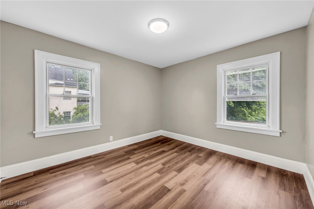 3528 Daleford Road Cleveland, OH 44120 - Photo 7 of 30 Empty room featuring healthy amount of natural light, baseboards, and wood finished floors