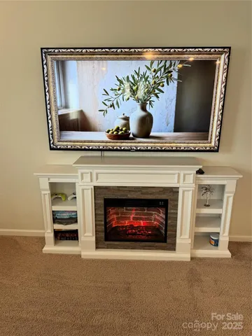 a living room with a fireplace and a potted plant