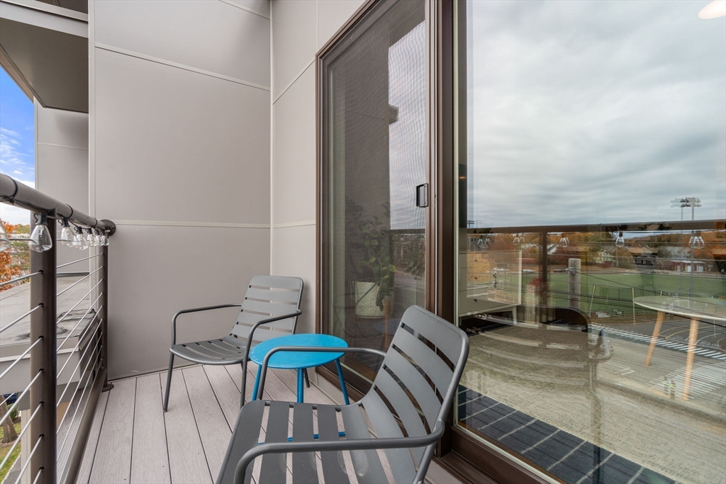 3 Bennett Street, Unit 402 Wakefield, MA 01880 - Photo 11 of 23 a view of a balcony with dining area