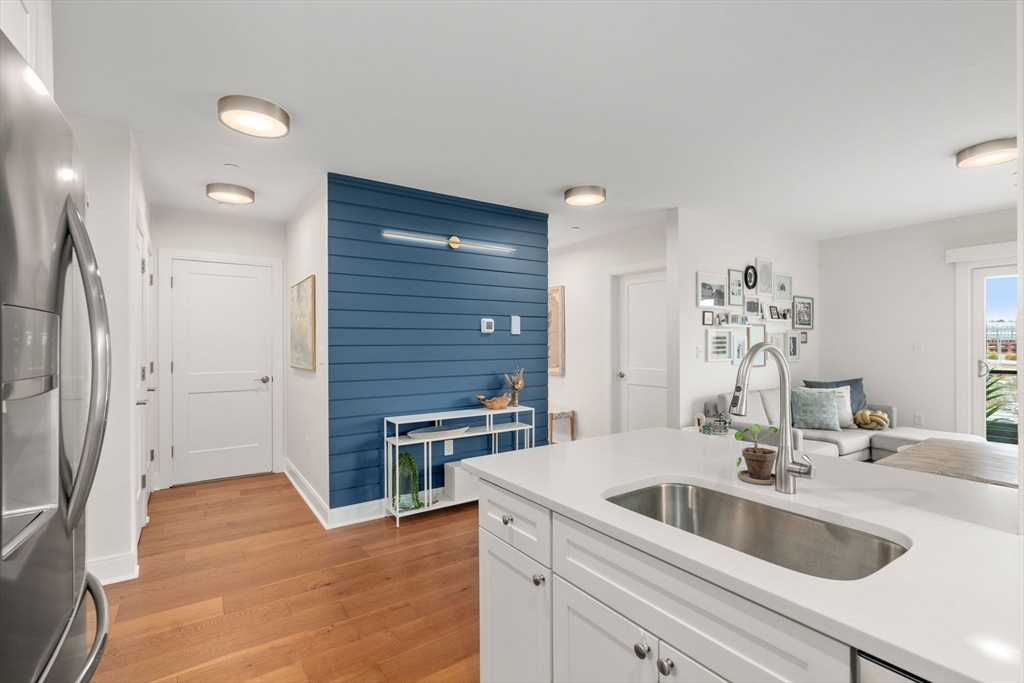 3 Bennett Street, Unit 402 Wakefield, MA 01880 - Photo 5 of 23 a kitchen with a sink and a refrigerator
