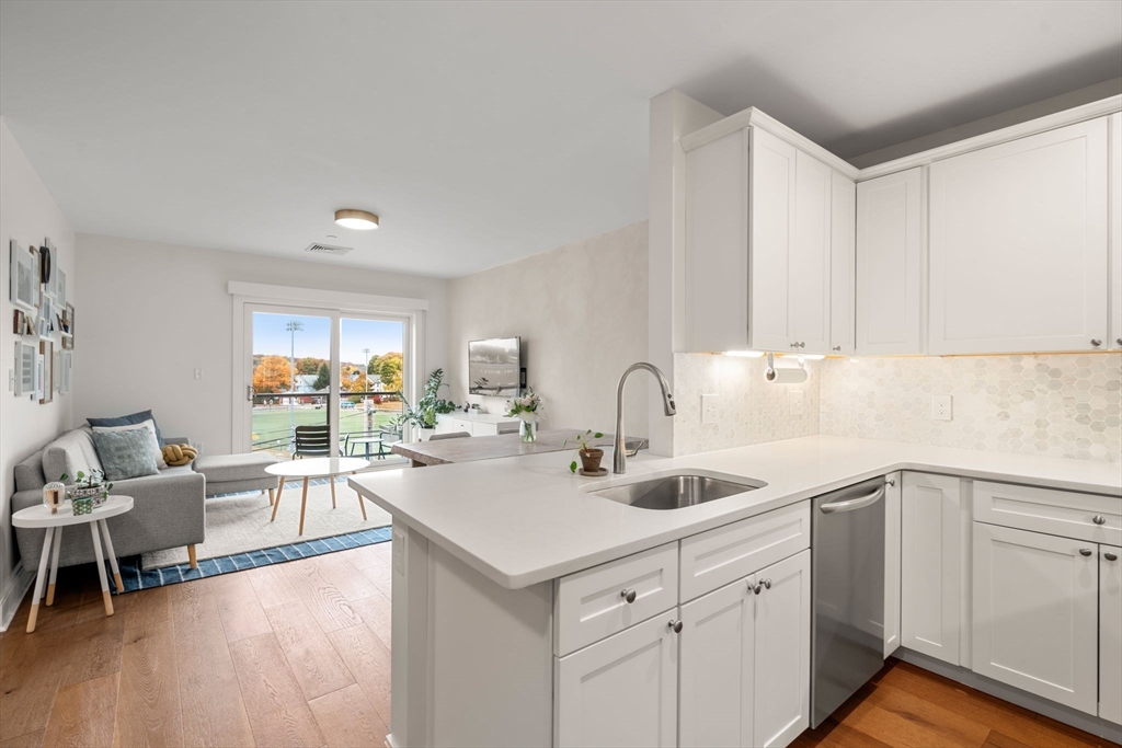 3 Bennett Street, Unit 402 Wakefield, MA 01880 - Photo 6 of 23 a view of a kitchen counter space with sink and couch