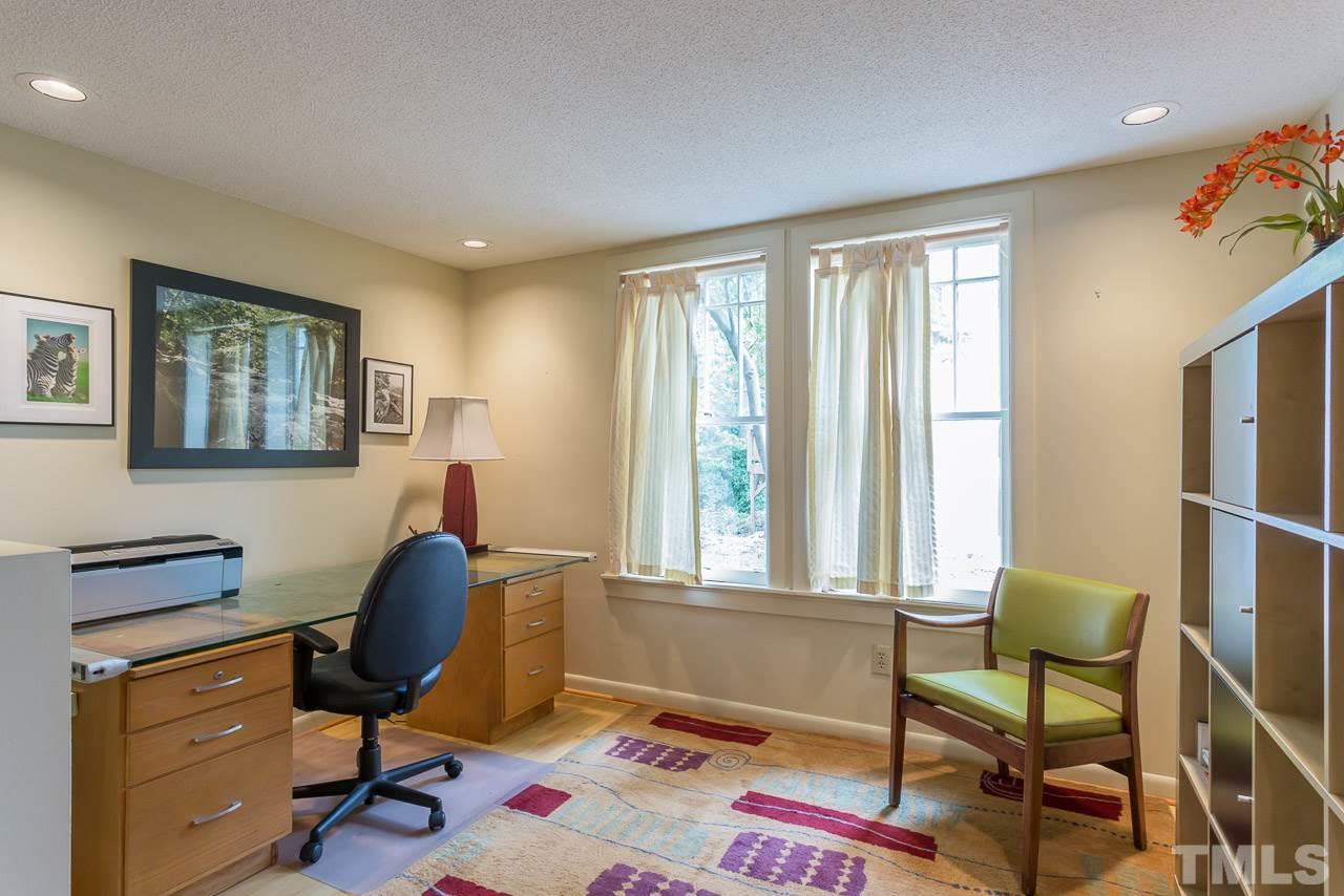 2276 The Circle Raleigh, NC 27608 - Photo 12 of 25 a view of a workspace with furniture and a window