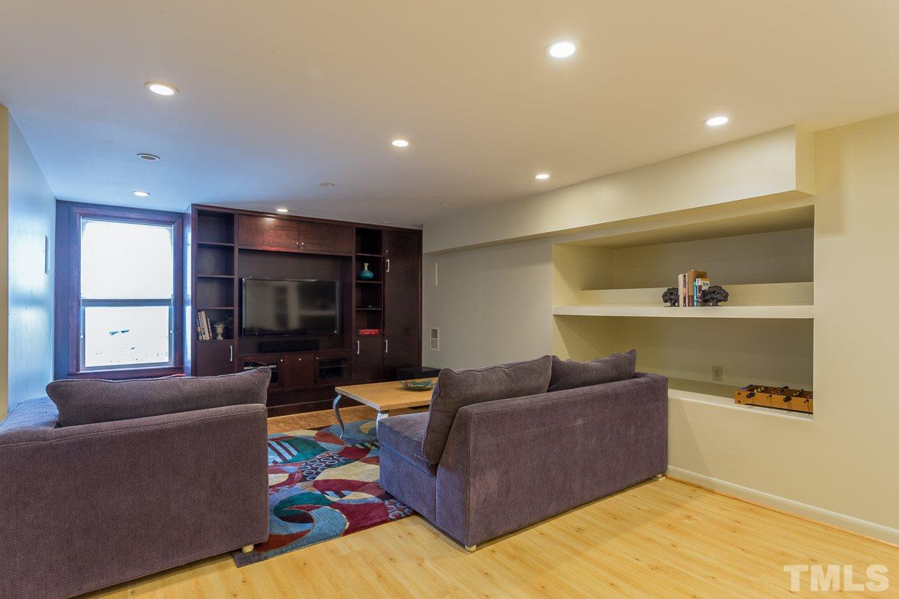 2276 The Circle Raleigh, NC 27608 - Photo 13 of 25 a living room with furniture and a flat screen tv