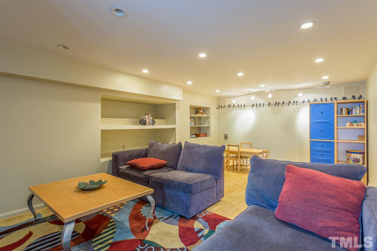 2276 The Circle Raleigh, NC 27608 - Photo 14 of 25 a living room with furniture and a table