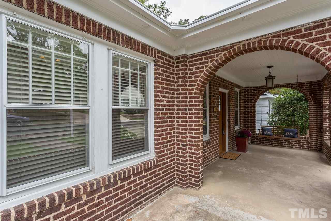 2276 The Circle Raleigh, NC 27608 - Photo 19 of 25 a view of a porch with a table and chairs