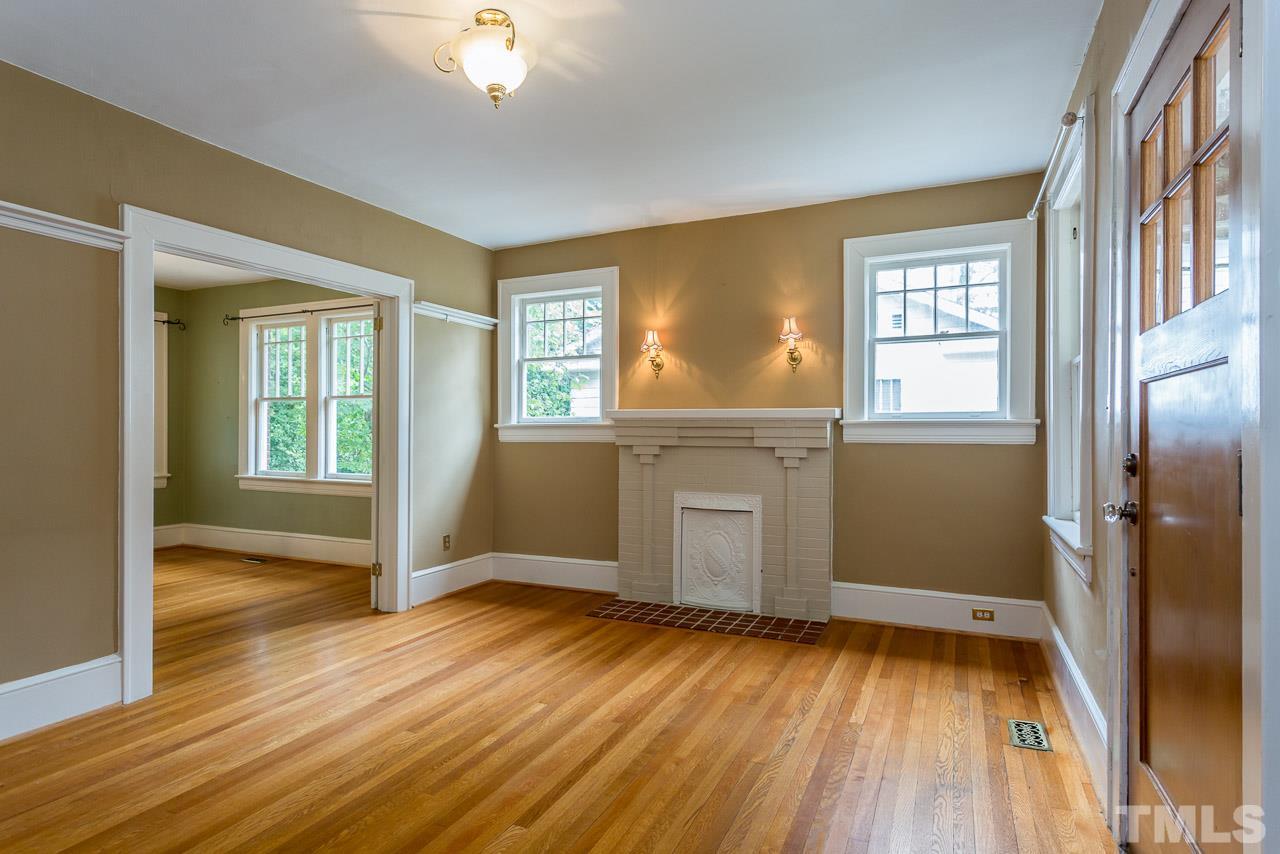 2276 The Circle Raleigh, NC 27608 - Photo 2 of 25 an empty room with wooden floor and windows