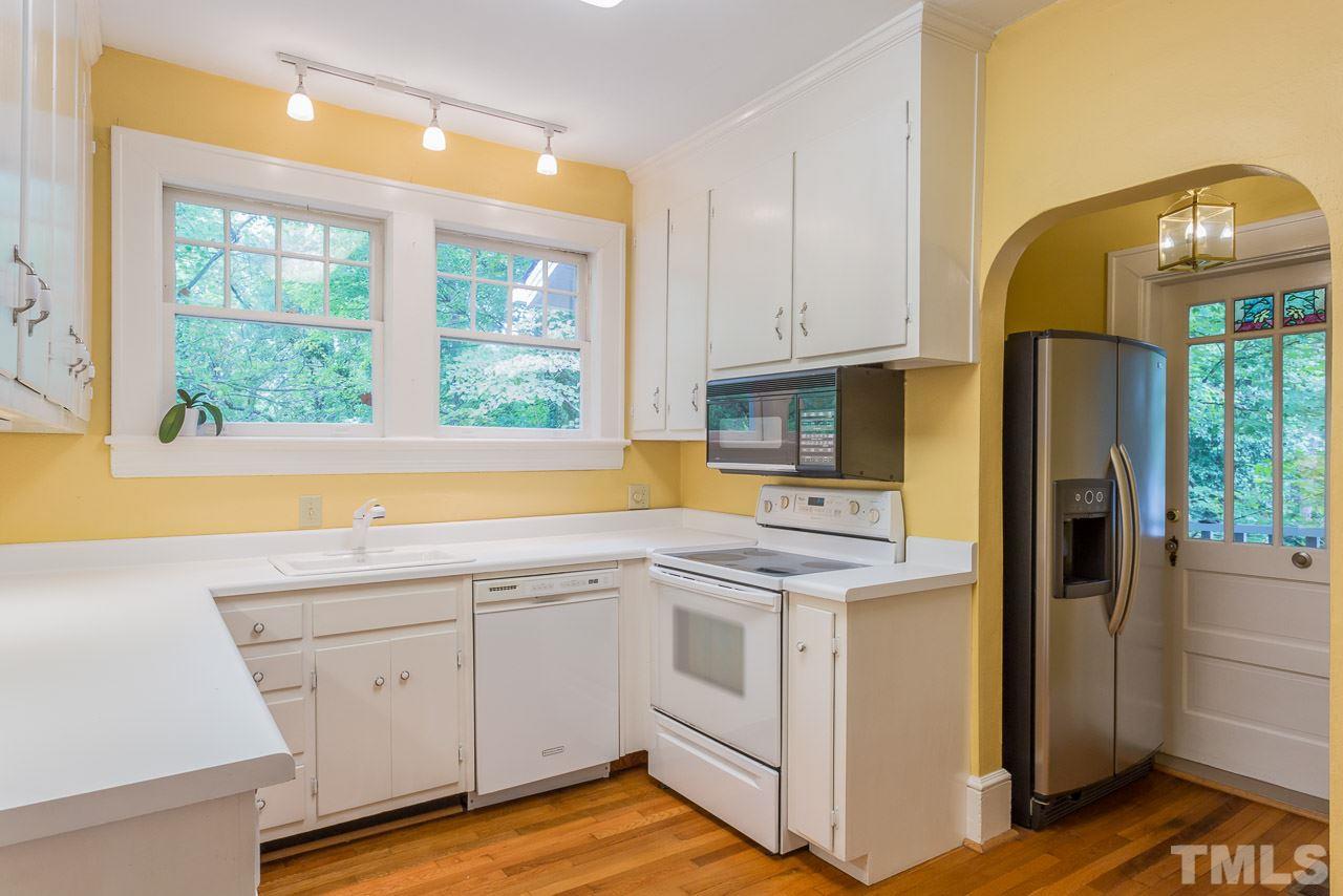 2276 The Circle Raleigh, NC 27608 - Photo 6 of 25 a kitchen with a sink cabinets stainless steel appliances and a window