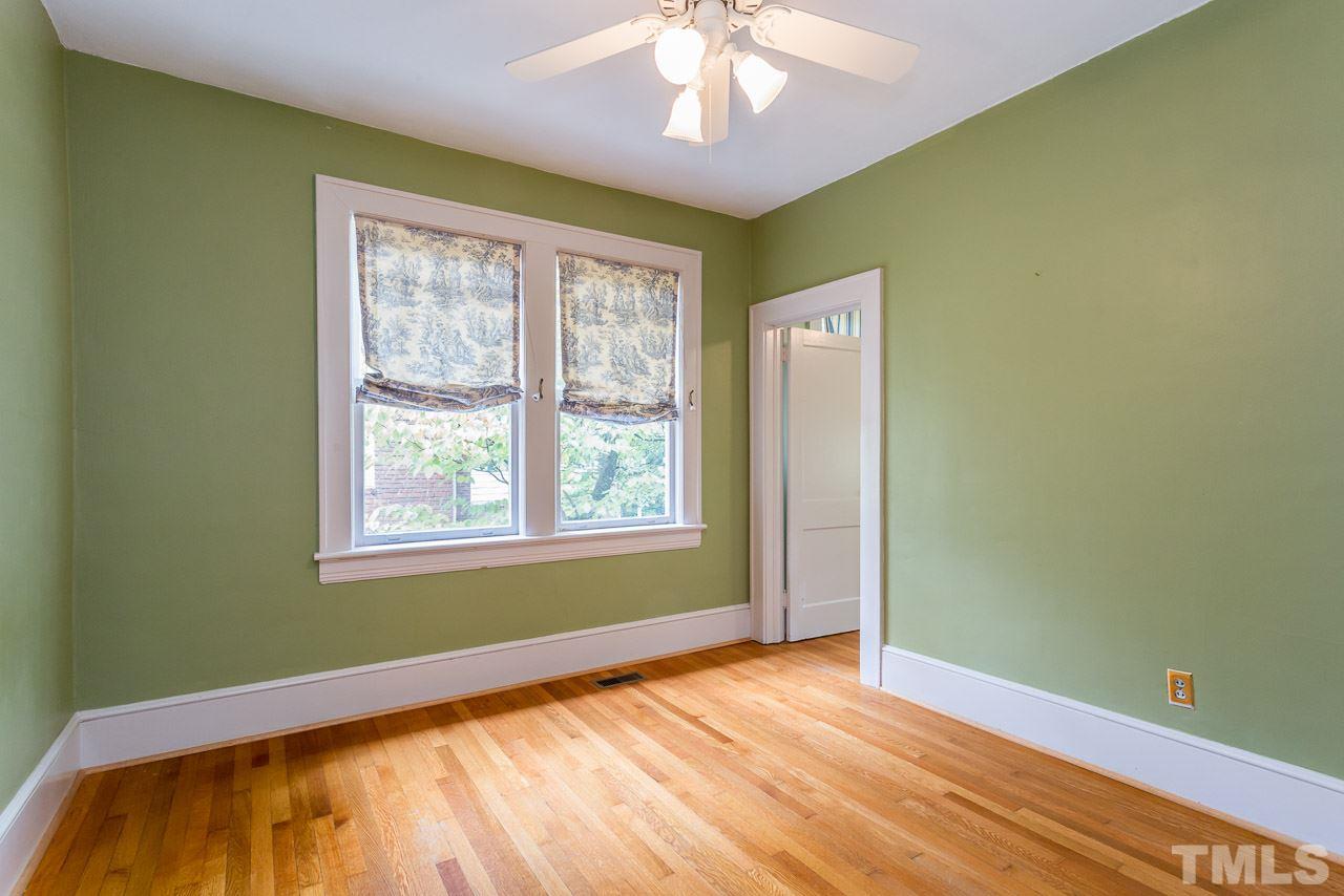 2276 The Circle Raleigh, NC 27608 - Photo 8 of 25 a view of an empty room with wooden floor and a window