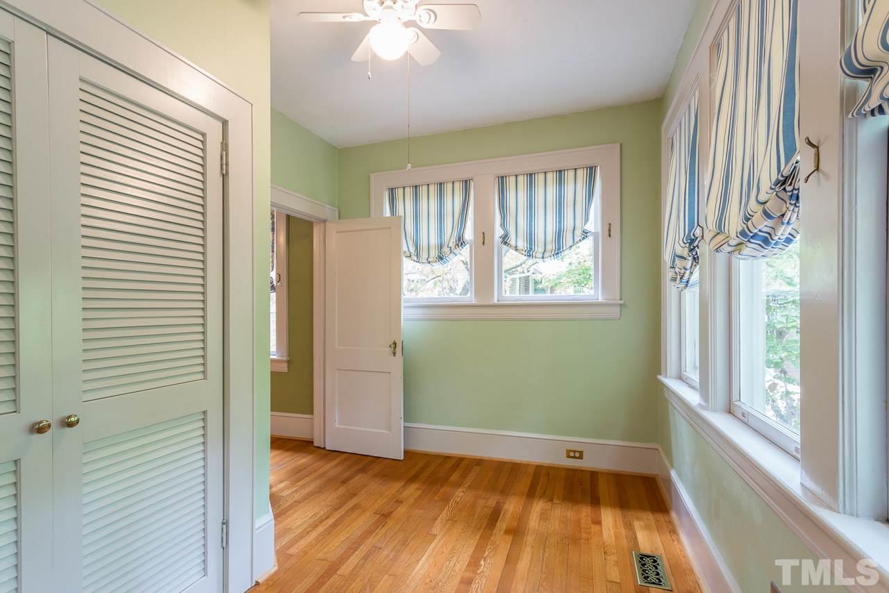2276 The Circle Raleigh, NC 27608 - Photo 9 of 25 a view of an empty room with a window and wooden floor