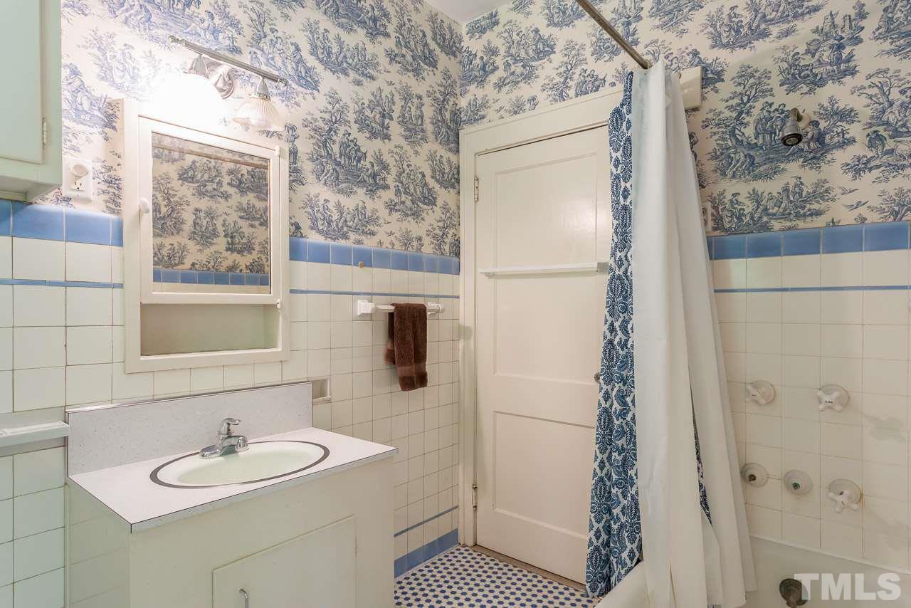 2276 The Circle Raleigh, NC 27608 - Photo 10 of 25 a bathroom with a sink and a mirror