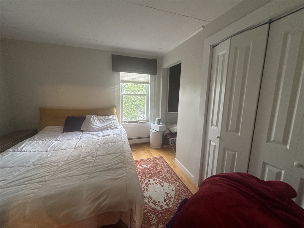 12 Pearl St Place, Unit 3 Somerville, MA 02145 - Photo 1 of 12 a bedroom with a bed and a window