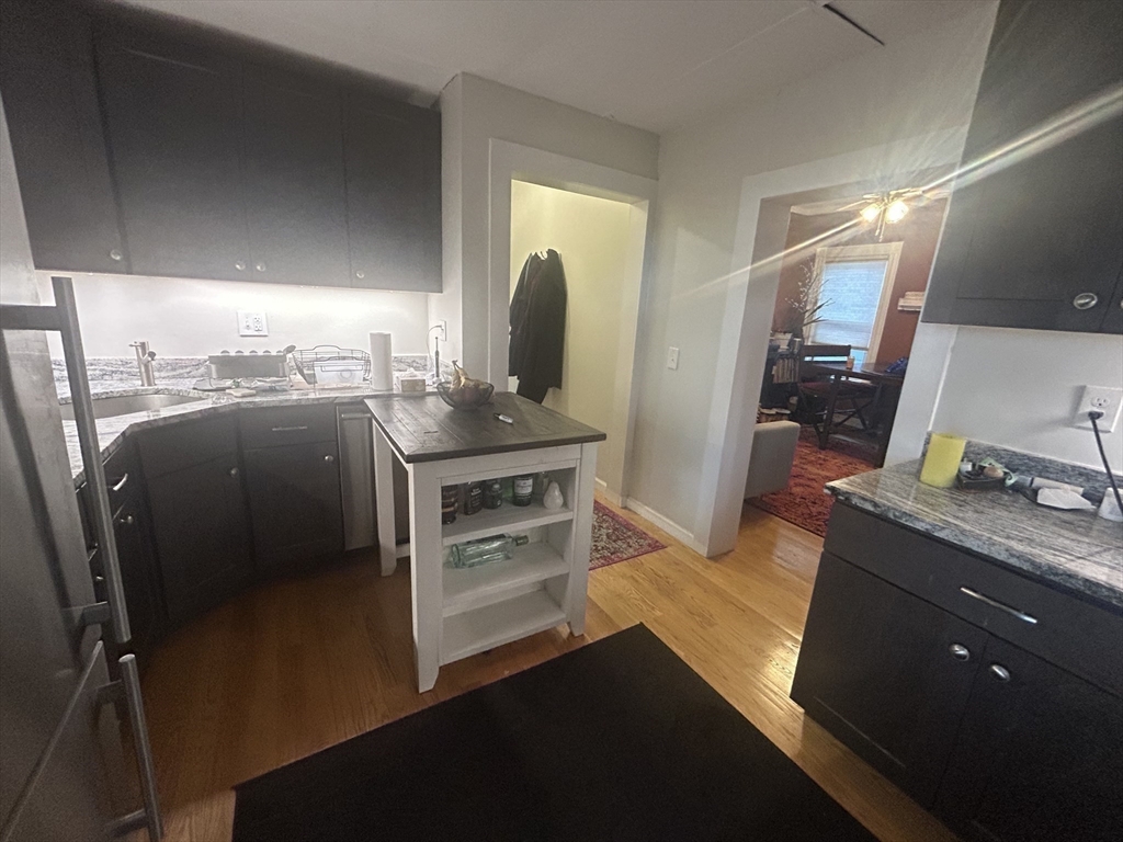 12 Pearl St Place, Unit 3 Somerville, MA 02145 - Photo 11 of 12 a kitchen with stainless steel appliances granite countertop a sink stove and refrigerator