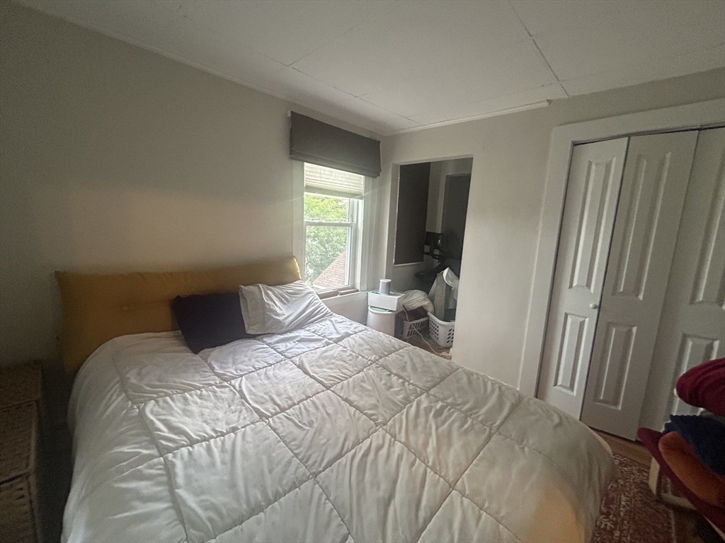 12 Pearl St Place, Unit 3 Somerville, MA 02145 - Photo 3 of 12 a bedroom with a bed and a large window