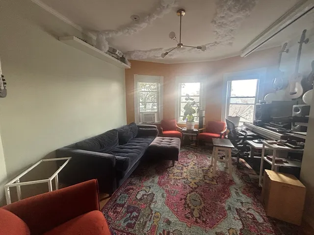 a living room with furniture and a chandelier