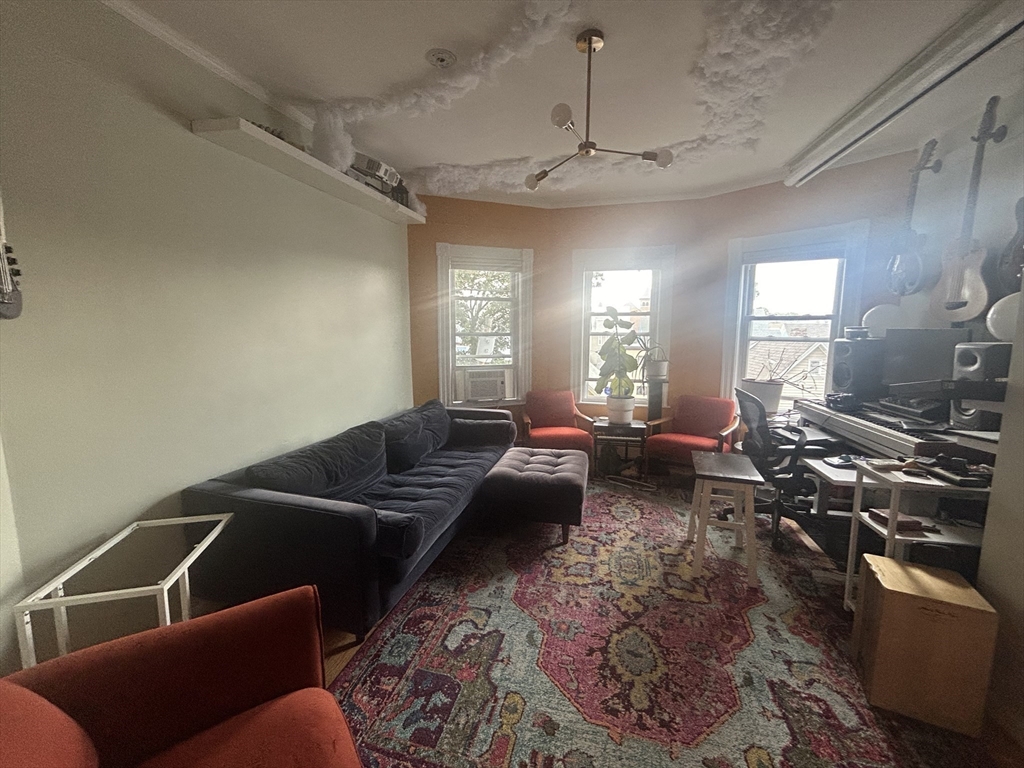 12 Pearl St Place, Unit 3 Somerville, MA 02145 - Photo 4 of 12 a living room with furniture and a chandelier