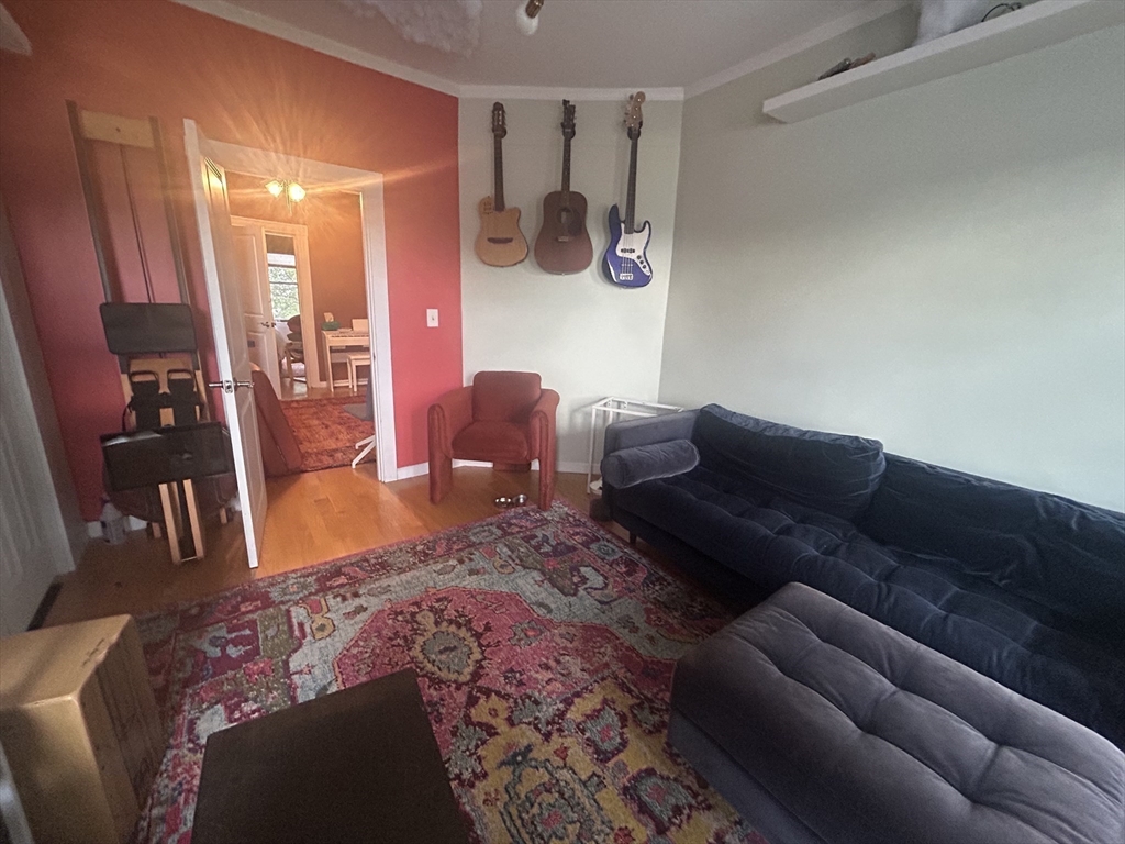 12 Pearl St Place, Unit 3 Somerville, MA 02145 - Photo 5 of 12 a living room with furniture and wooden floor
