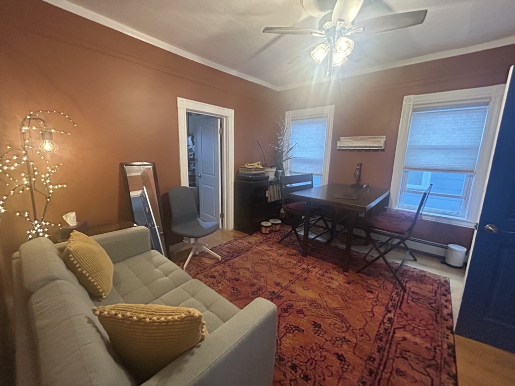 12 Pearl St Place, Unit 3 Somerville, MA 02145 - Photo 7 of 12 a living room with furniture and a chandelier