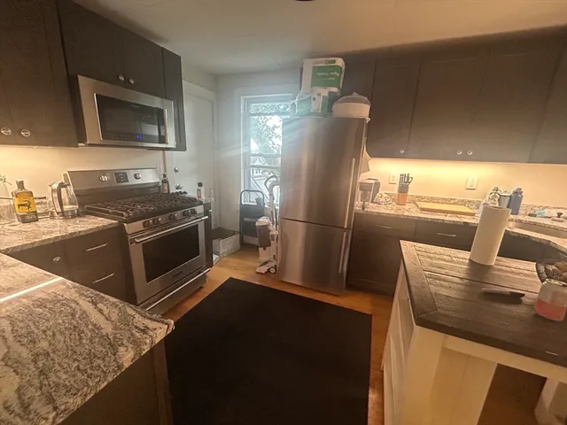 a kitchen with a sink stove and refrigerator