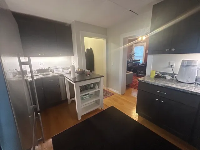 a kitchen with stainless steel appliances a sink stove and refrigerator